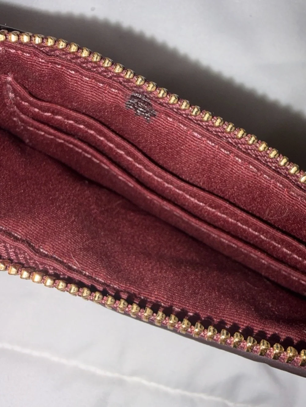 COACH Embossed Signature Wristlet in burgundy with Gold Logo, used once